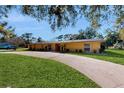 Charming single-story home features well-manicured lawn, long drive, and a stylish front entrance at 926 Ensenada Dr, Orlando, FL 32825