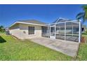 A covered, screened-in back porch area with concrete flooring, perfect for outdoor relaxation at 1010 High Vista Dr, Davenport, FL 33837