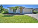 Beautiful single-story home with green lawn, landscaping, and a brick paved driveway at 1010 High Vista Dr, Davenport, FL 33837