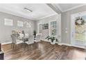 Bright dining room featuring wood floors, a glass table with seating for six, and ample natural light at 13333 Beebe Aly, Orlando, FL 32827