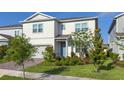 Charming two-story home showcasing a manicured lawn and lovely landscaping at 13348 Panama Beach Ct, Orlando, FL 32827
