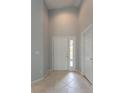 Inviting entryway with neutral walls, tile flooring and a coat closet at 17343 Summer Oak Ln, Clermont, FL 34711