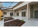 Spacious outdoor patio with natural rock landscaping, covered with a lattice roof at 17343 Summer Oak Ln, Clermont, FL 34711