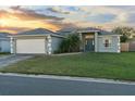 Inviting single-story home features a manicured lawn and a charming entryway at 1879 Grey Fox Dr, Lakeland, FL 33810