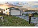 Well-kept home features a manicured lawn, mailbox, and two-car garage at 1879 Grey Fox Dr, Lakeland, FL 33810