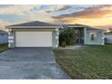 Charming single-story home with a two-car garage and a well-manicured lawn at 1879 Grey Fox Dr, Lakeland, FL 33810