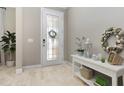 Bright foyer featuring decorative wreaths, a decorative entry door, and wood-look flooring at 204 Pine Crest Rd, Mount Dora, FL 32757