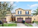 Inviting townhomes featuring garages, manicured lawns, and covered front entryways at 20648 Maxim Pkwy Pkwy, Orlando, FL 32833