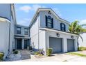 Charming townhomes with two stories, gray paint, black shutters, and attached garages at 20648 Maxim Pkwy Pkwy, Orlando, FL 32833