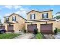 Townhome featuring a garage and a well maintained lawn at 20648 Maxim Pkwy Pkwy, Orlando, FL 32833