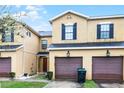 Townhome exterior featuring a garage and a well maintained lawn at 20648 Maxim Pkwy Pkwy, Orlando, FL 32833