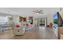 Open-concept living room featuring hardwood floors, neutral tones, and sliding glass doors to the patio at 2233 Tulip Valley Pt, Sanford, FL 32771