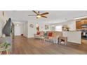 Bright and airy living room with hardwood floors connecting to the kitchen and dining area at 2233 Tulip Valley Pt, Sanford, FL 32771