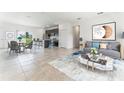 Open concept living room featuring tile floors, stylish furniture, and natural light, adjacent to the modern kitchen at 267 Marion Oaks Golf Rd, Ocala, FL 34473