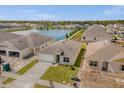 Aerial view of a home with a lake view, showcasing the property's setting within a residential community at 2921 Sunridge Loop, St Cloud, FL 34771