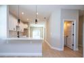 Bright, modern kitchen with an open layout featuring white cabinets and a breakfast bar at 313 Mandrake St, Orlando, FL 32811