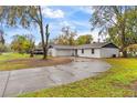 Beautiful home exterior featuring a long, curved driveway and lush landscaping at 3325 Dove Ln, Mulberry, FL 33860