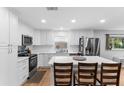 Bright kitchen with white cabinets, stainless steel appliances, and a spacious center island at 3325 Dove Ln, Mulberry, FL 33860