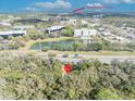 Aerial view of property near UCF featuring a serene pond and lush green surroundings at 3508 Rouse Rd, Orlando, FL 32817