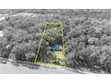 Aerial view of property outlined in yellow, surrounded by trees and road access at 3508 Rouse Rd, Orlando, FL 32817