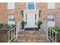 A welcoming entrance with a brick staircase, white railings, and potted plants at 4214 Lake Underhill Rd # A, Orlando, FL 32803