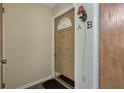 A well-lit front door and welcome mat in a condo entryway at 4214 Lake Underhill Rd # A, Orlando, FL 32803