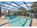 Screen-enclosed pool with brick-paver deck and safety fence at 460 Forestwood Ln, Maitland, FL 32751