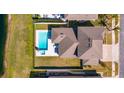 Aerial view of backyard with pool and spa, patio area, and manicured lawn at 5142 Sage Cedar Pl, Sanford, FL 32771