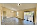 Spacious living room featuring tile floors, neutral paint and a glass sliding door to the lanai at 5317 Hyde Park Ave, Orlando, FL 32808