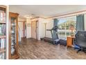 Cozy living room featuring wood-look flooring, a large window, and comfortable furnishings at 8155 Brocatel Ct, Orlando, FL 32822