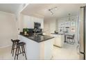 Well-lit kitchen featuring granite counters, white cabinets, and stainless steel appliances at 911 N Orange Ave # 110, Orlando, FL 32801