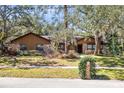 Inviting single-story home with mature trees, lush landscaping, and a well-maintained front yard at 916 Puma Trl, Winter Springs, FL 32708