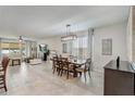 Bright and airy living room featuring tile floors, neutral decor, and ample natural light at 10139 Grande Loop, Clermont, FL 34711