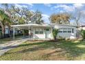 Close up view of a charming home featuring a covered carport and freshly painted exterior at 1140 W Seminole Trl, Bartow, FL 33830