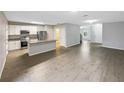Spacious living area with modern gray walls, light tile floors and an open kitchen at 1613 Reflection Cv, St Cloud, FL 34771