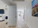 Bright hallway with tile floors leads to various rooms, showcasing the open layout and cohesive design elements at 1705 S Atlantic Ave # 402, New Smyrna Beach, FL 32169