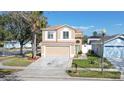 Two-story tan home with attached garage, manicured lawn and a classic mailbox at 1801 Seatonham St # 1, Winter Garden, FL 34787