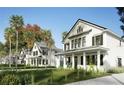 Quaint two-story white homes with black shutters, covered porches, and tropical landscaping at 1987 Peel Ave, Orlando, FL 32806