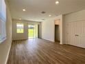 Bright and airy living room with sliding glass doors leading to an outdoor space at 2668 Spider Lily Ct, Clermont, FL 34711