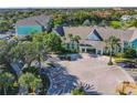 Community aerial view showing Runaway Bay Condominiums buildings, lake, and mature trees at 3002 Bonfire Beach Dr # 202, Kissimmee, FL 34746