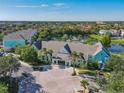 Aerial view of Runaway Bay Condominiums with lake, manicured landscaping, and colorful buildings at 3002 Bonfire Beach Dr # 202, Kissimmee, FL 34746