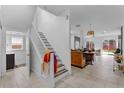 Hallway with white stairway leading to an open-concept living space at 3007 E Central Blvd # 3007, Orlando, FL 32803