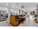 Open kitchen with white cabinets, stainless steel appliances, and a unique dining area at 3007 E Central Blvd # 3007, Orlando, FL 32803