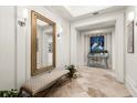 Refined hallway featuring a mirror, bench, and stylish decor, leading to other rooms in the home at 315 E New England Ave # 30, Winter Park, FL 32789