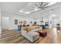 Spacious living room with a modern ceiling fan, hardwood floors, and an open floor plan at 3186 Sailing Pier Ave, Winter Garden, FL 34787