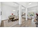 Bright dining area featuring stylish decor, decorative columns, and views into the living room at 3351 Pine Timber Pt, Oviedo, FL 32765