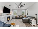 Bright living room featuring a fireplace, large windows, and a comfortable sectional sofa at 34000 Fortunado St, Sorrento, FL 32776