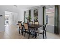 Elegant dining room with modern table, chairs, and ample natural light at 3615 Salvia Ct, Tavares, FL 32778