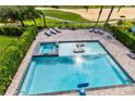 Inviting backyard pool and spa area, surrounded by an ample patio space with comfortable lounge chairs at 415 Muirfield Loop, Reunion, FL 34747