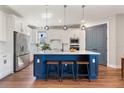 Modern kitchen featuring stainless steel appliances, a large island, and pendant lighting at 4210 Sunset Preserve Blvd, Orlando, FL 32820